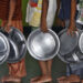 Children holding plates wait in a queue to receive food at an orphanage in the southern Indian city of Chennai May 28, 2014. REUTERS/Babu (INDIA - Tags: SOCIETY)