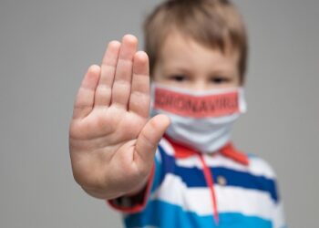 Young child wearing a respiratory mask as a prevention against the deadly Coronavirus Covid-19