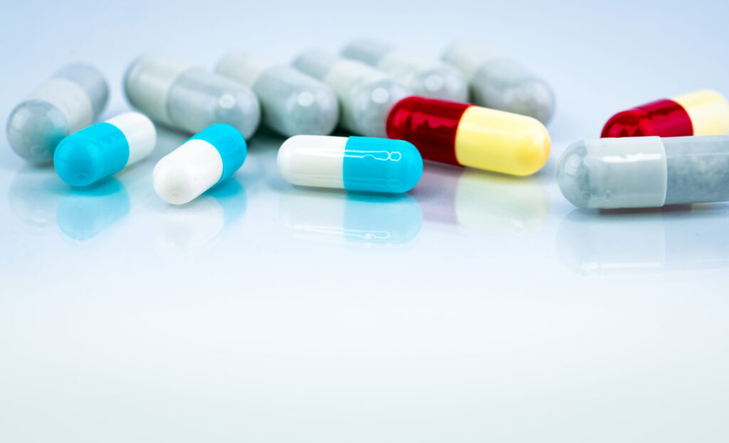 Colorful capsule pills on white background