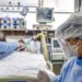 A patient infected with the novel coronavirus COVID-19 receives treatment at the Intensive Care Unit of the Hospital de Clinicas, in Porto Alegre, Brazil, on April 15, 2020. - With Brazilians increasingly ignoring health officials' warnings to stay home -- encouraged by their far-right president Jair Bolsonaro, who has condemned the "hysteria" over the virus -- predictions for how the pandemic will play out in the hardest-hit country in Latin America are getting dire. (Photo by Silvio AVILA / AFP)