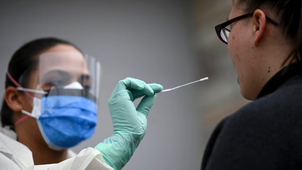Fridley health workers demonstate COVID-19 drive-up testing