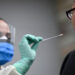 Fridley, MN March 10: Reece Wallaker, a medical assistant with M Health Fairview, administered a COVID-19 test to an actor and fellow Fairview employee, Nichole Brown, outside the M Health Fairview Fridley clinic Tuesday. (Photo by Aaron Lavinsky/Star Tribune via Getty Images)