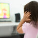 A child watching tv holding her ears because she is afraid of the sound; Child behavior theme