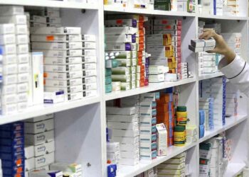 FILE - In this Nov. 5, 2018 file photo, a drugstore employee pics medicine from shelf in downtown Tehran, Iran. (AP Photo/Ebrahim Noroozi)